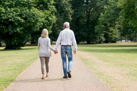 image of couple walking in a park